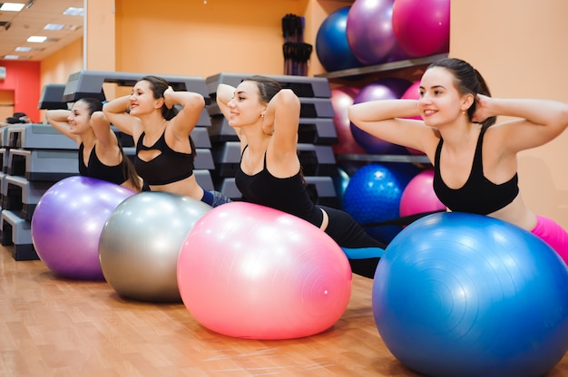 Belas mulheres caucasianas fazendo exercício com bola de ginástica