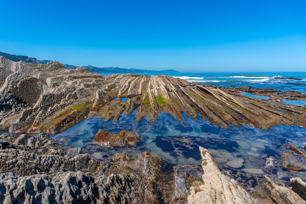 Foto belas paisagens do geoparque flysch da costa basca em zumaia com mares baixos gipuzkoa