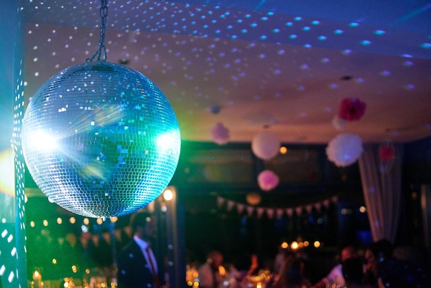 Foto beleuchteter disco-ball hängt auf der party