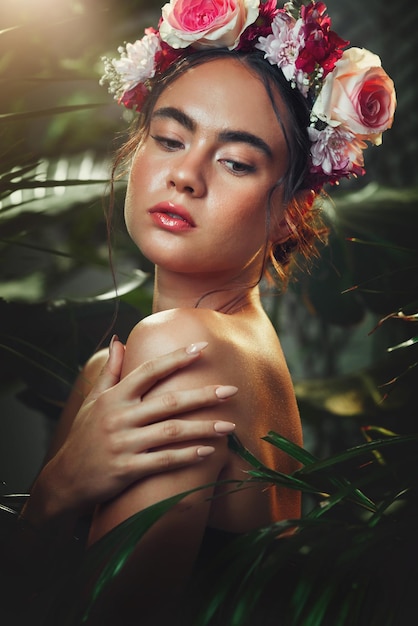 Beleza de mulher e tiara de flores na floresta para tratamento cosmético da pele Modelo jovem brilho natural saudável da pele e cuidados corporais de bem-estar na floresta tropical de plantas ao ar livre com coroa floral rosa