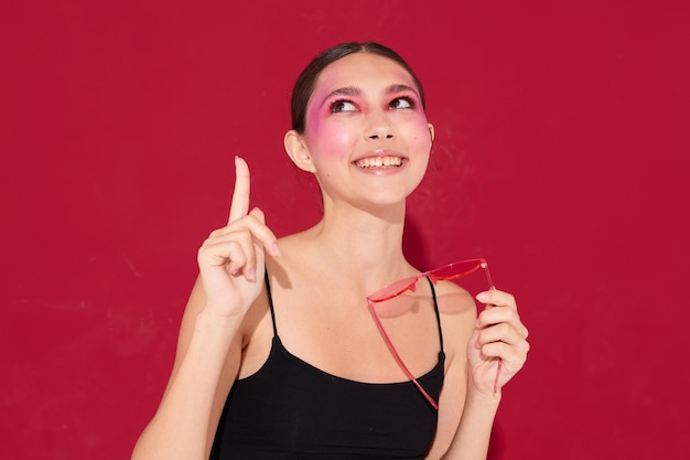 Beleza moda feminina óculos rosa maquiagem brilhante posando camisa preta fechada inalterada