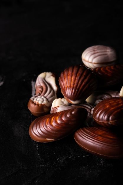 Belgische Schokoladenmuscheln auf einem schwarzen Tisch