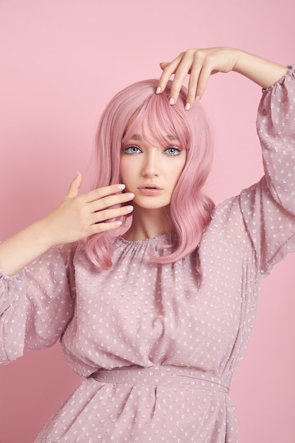 Bella mujer con cabello rosado y vestido