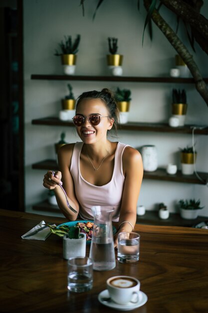 Una bella mujer desayuna en un elegante café