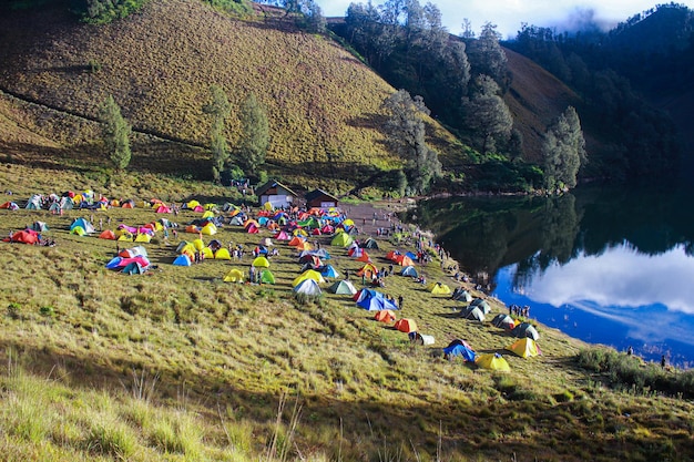 Belo acampamento à beira do lago com tendas coloridas