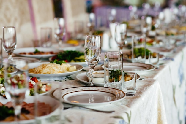 Belo cenário de mesa com louças e flores para uma festa de casamento ou outro evento festivo Copos e talheres para jantar de evento servido