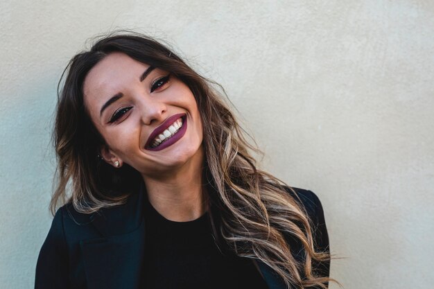 Belo retrato de uma garota feliz. Mulher com cabelo comprido em um fundo branco.