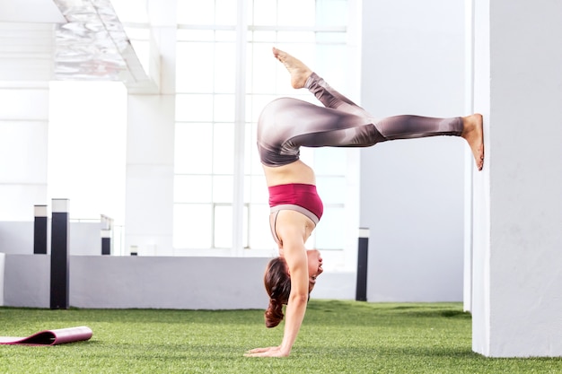 Übendes Yoga der Frau im Park - gesunder Lebensstil
