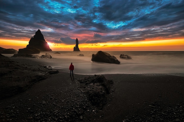Beobachter am schwarzen vulkanischen Sandstrand von Viks in Island