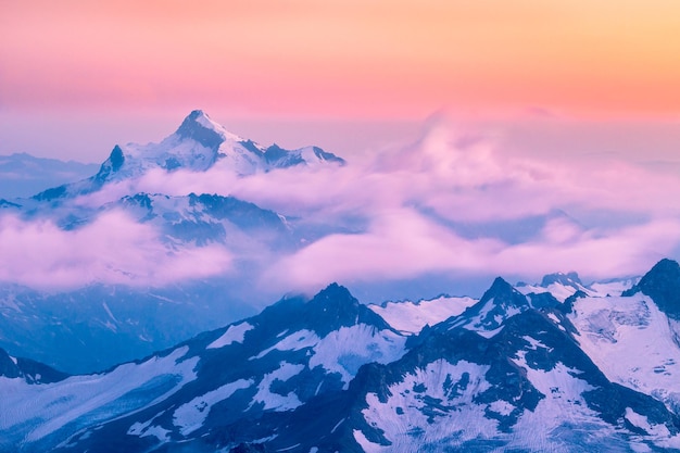 Berge und sich bewegende Wolken bei Sonnenuntergang