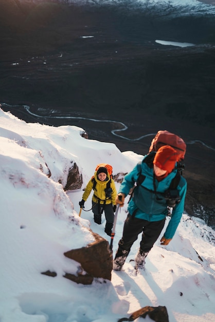 Bergsteiger erklimmen einen verschneiten Liathach Ridge in Schottland