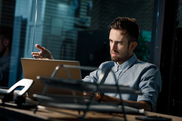 Überraschter Mann am Laptop im Büro