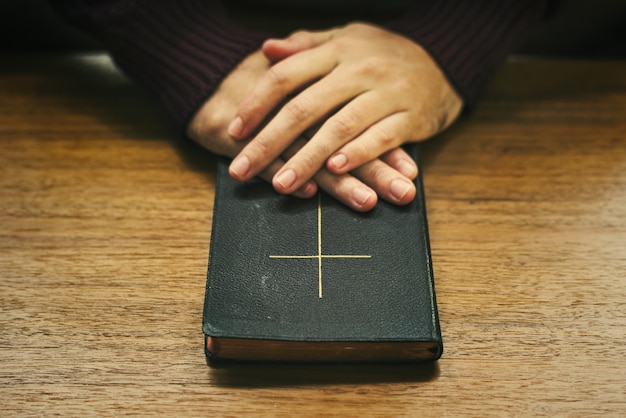 Überreicht die Bibel auf einem Holztisch