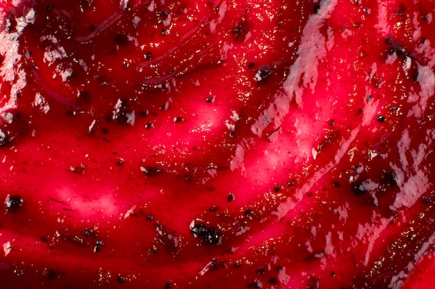 Berry jam vermelho escuro espalhado no fundo liso ou
