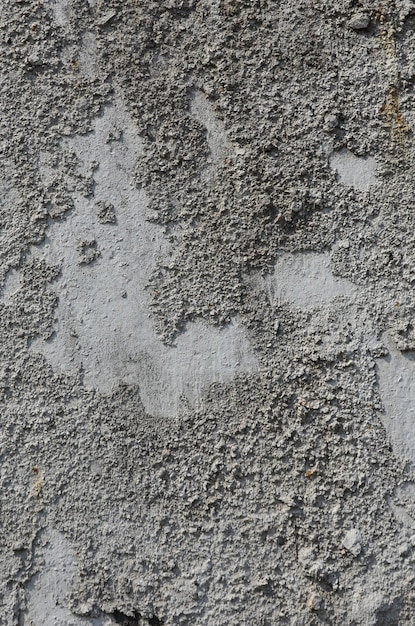 Beschaffenheit der alten geprägten Betonmauer in der grauen Farbe. Hintergrundbild eines konkreten Produktes