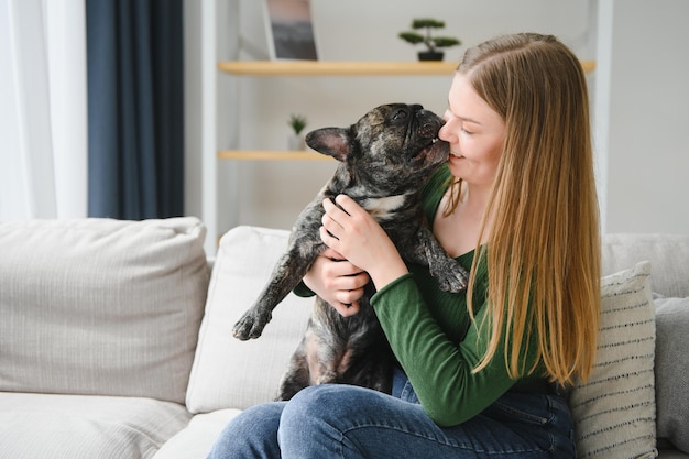 Besitzerin spielt zu Hause mit fröhlichem Hund Spielen mit dem Hundekonzept