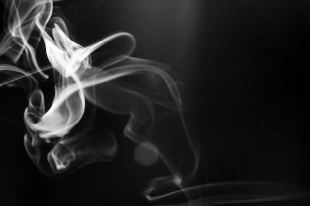 Bewegung des weißen Rauchs auf schwarzem Hintergrund.