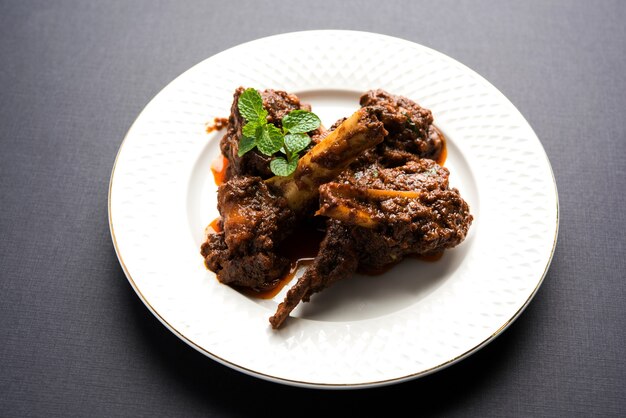 Bhuna Gosht Mutton Masala ODER indisches Lammcurry Serviert in einer Schüssel über stimmungsvollem Hintergrund. Selektiver Fokus