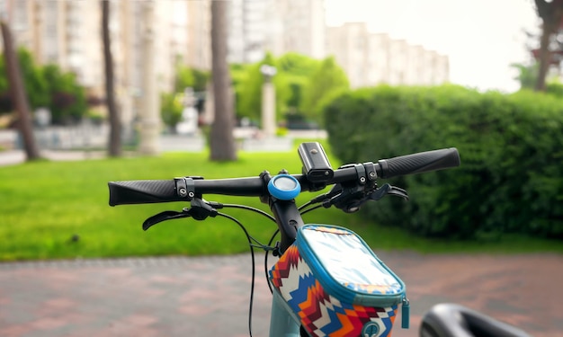 Bicicleta de cerca contra el fondo del parque manillar con accesorios