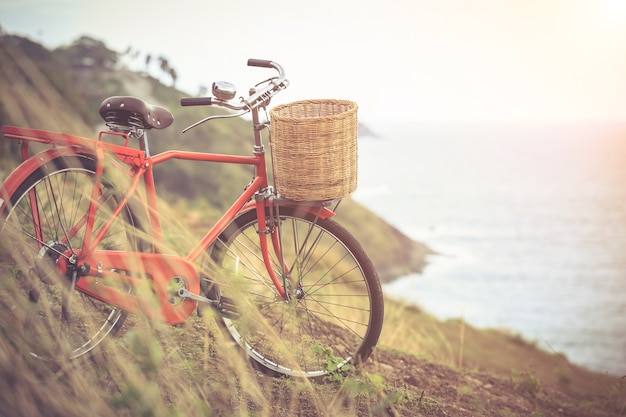 Bicicleta clásica del estilo rojo de Japón en el punto de vista del océano, efecto del filtro de la vendimia