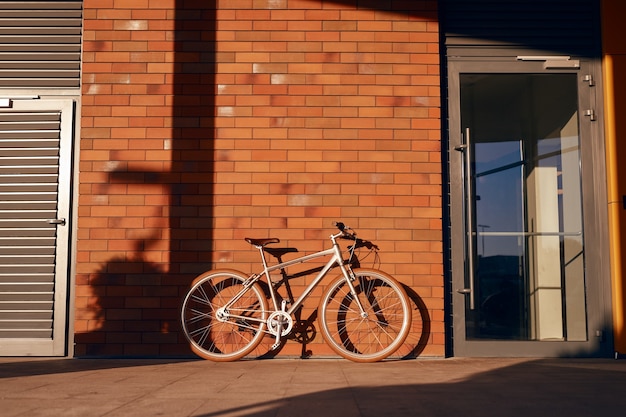 Bicicleta estacionada perto de prédio de tijolos