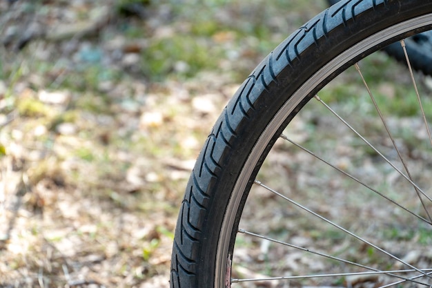 Bicicleta de montaña en el bosque para competiciones de campo traviesa La rueda trasera y el neumático de una bicicleta están cerrados contra el fondo de un camino de tierra