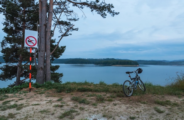 Bicicleta en la orilla del lago después del atardecer