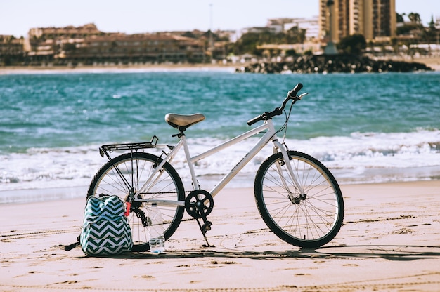 Bicicleta en la playa cerca del mar Mediterráneo con fondo de cielo de nubes
