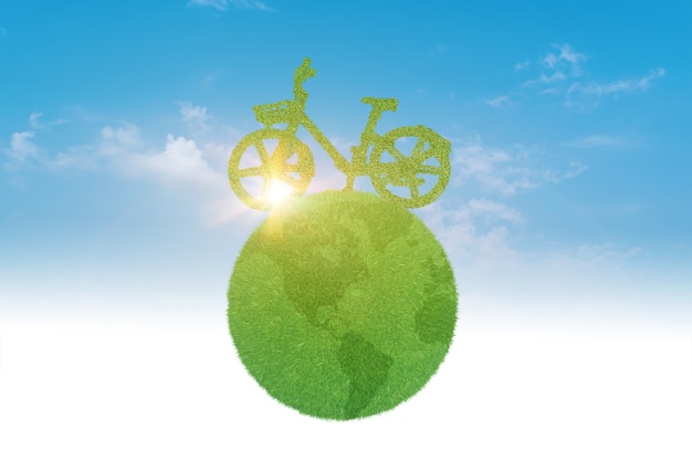 Bicicleta verde dirigindo com o planeta sobre o céu azul. conceito de meio ambiente e ecologia