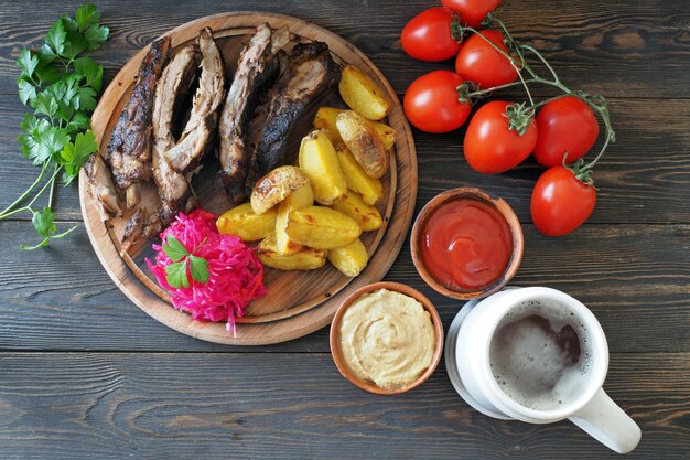 Bier in einem weißen Tonbecher und traditionelle Snacks auf einem rustikalen Tisch