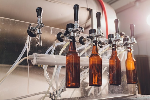 Foto bierfabrik, die bier in glasflaschen auf förderleitungen verschüttet industriearbeit automatisierte produktion von lebensmitteln und getränken technologische arbeit in der fabrik