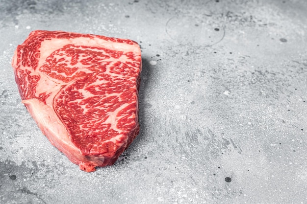Bife de carne de costela wagyu japonês Fundo cinza Vista superior Copiar espaço