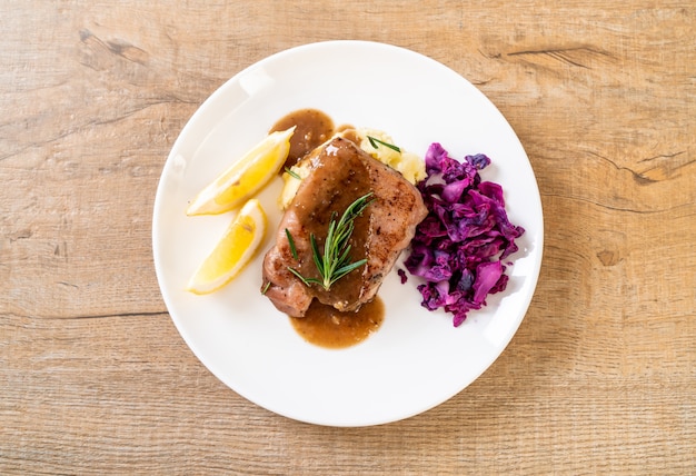 Bife de carne de porco com repolho roxo e purê de batatas