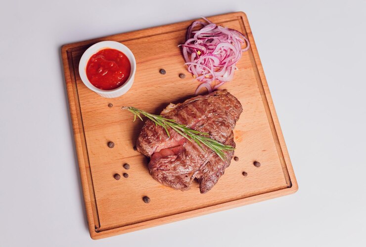 Foto bife de carne grande com osso grelhado servido com legumes grelhados milho cebola roxa pimento doce pote