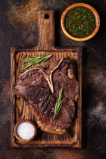 Bife grelhado com temperos em uma tábua de madeira