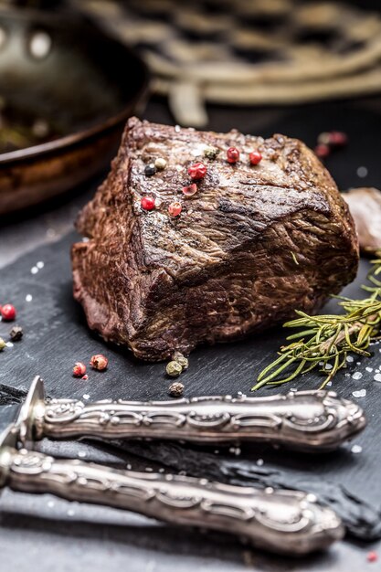 Bife suculento com especiarias e ervas na tábua.