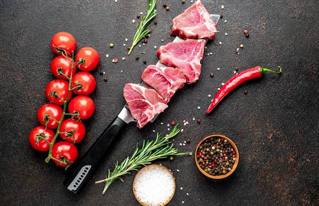 Bife T-Bone cru em uma faca em uma mesa de pedra