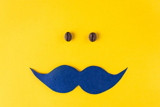 Foto bigode azul e grãos de café para o conceito movember