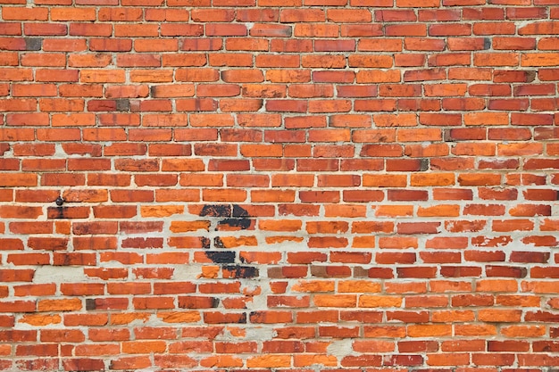 Bild der Textur der orangefarbenen und roten Backsteinmauer