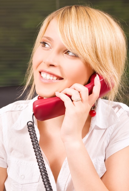 Foto bild des schönen mädchens mit telefon im büro