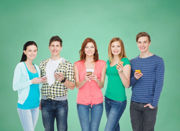 Bildung und modernes Technologiekonzept - lächelnde Studenten mit Smartphones