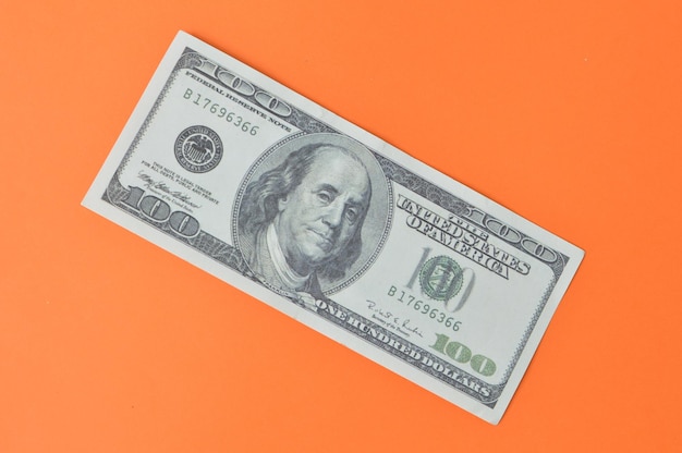 Billete de dinero sobre fondo naranja Vista superior