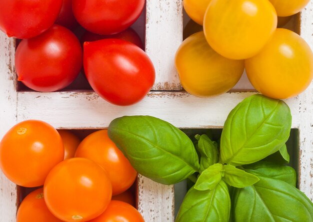 Bio Mini Tomaten mit Basilikum und Pfeffer in Holzkiste.