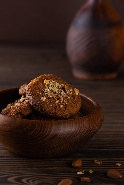 Biscoitos caseiros de quinua com nozes em uma tigela de madeira. Açúcar, sem glúten, sem lactose, vegan.