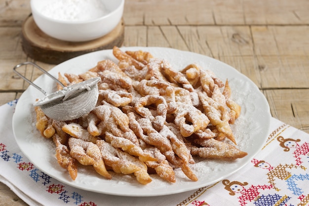 Biscoitos de asas de anjo, um prato doce europeu tradicional para o carnaval. estilo rústico.