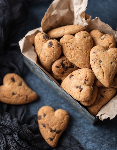 Biscoitos de chocolate na mesa rústica de madeira. Biscoitos de chocolate em forma de coração. Biscoitos caseiros