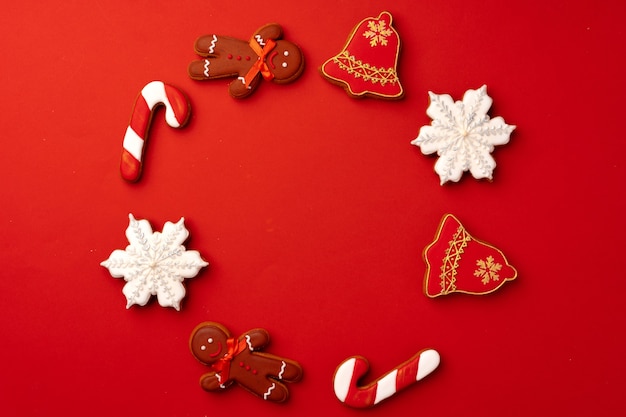 Biscoitos de gengibre de Natal na vista superior de fundo vermelho, copie o espaço