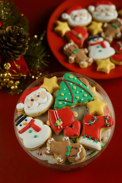 Biscoitos de natal com decoração de glacê real com fundo vermelho