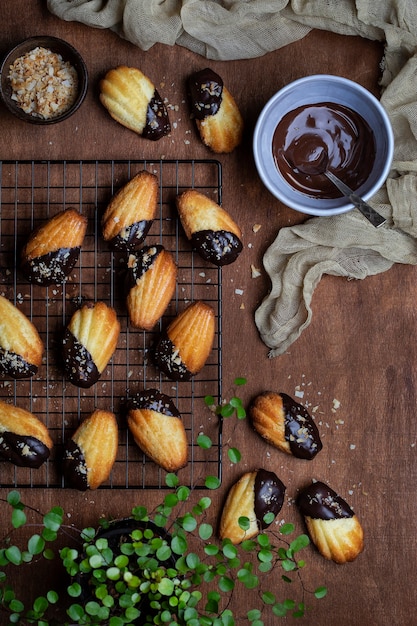 Biscoitos Madeleine com cobertura de chocolate e migalhas de coco