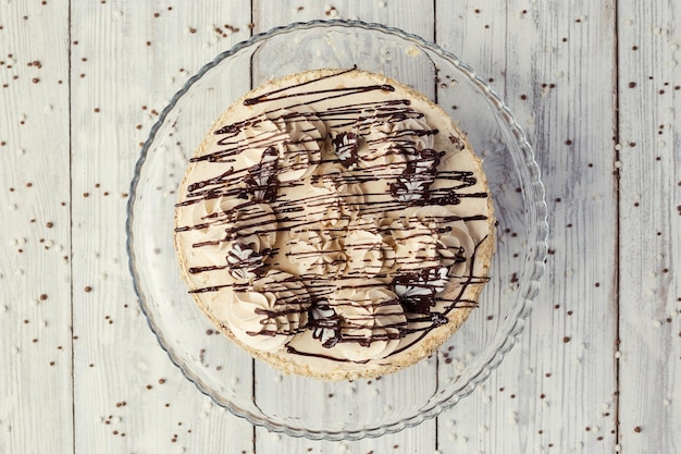 Biskuitkuchen mit Sahne, dekoriert mit Baiser und Schokolade